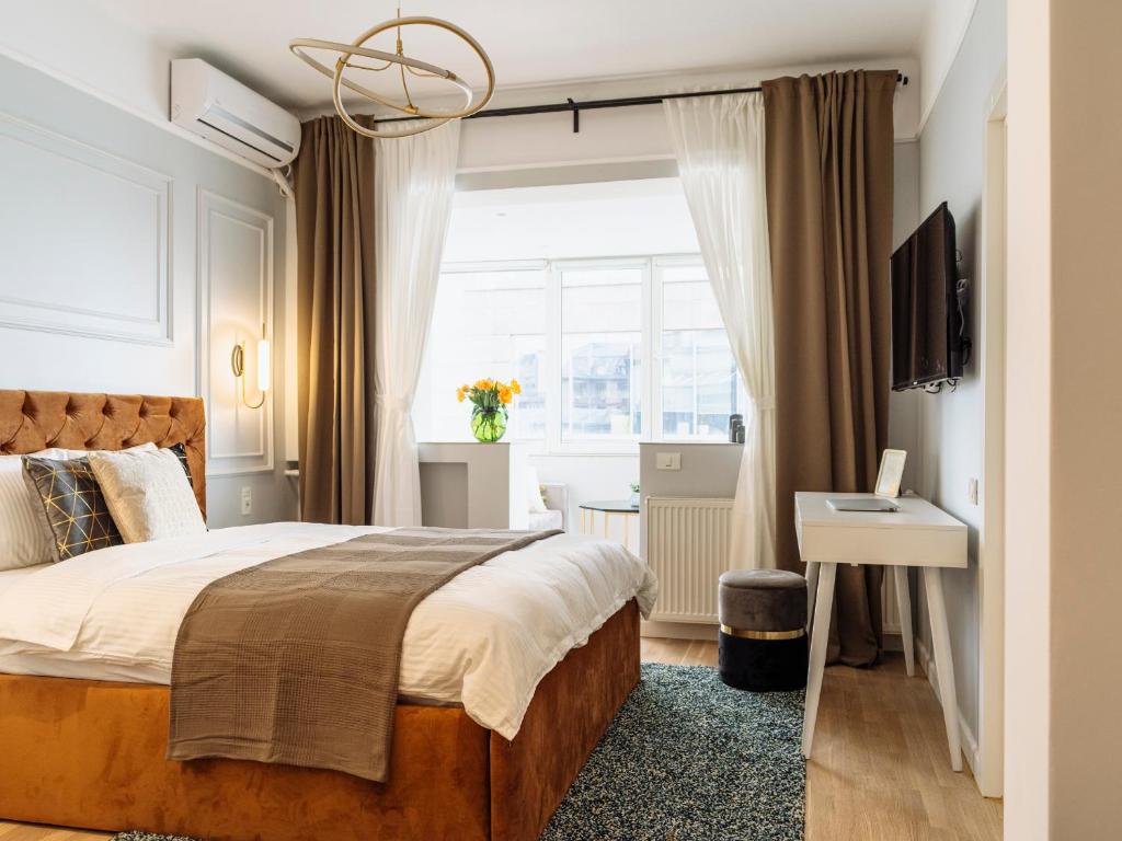 a bedroom with a large bed and a window at Elegant Cosy Studio - Calea Victoriei in Bucharest