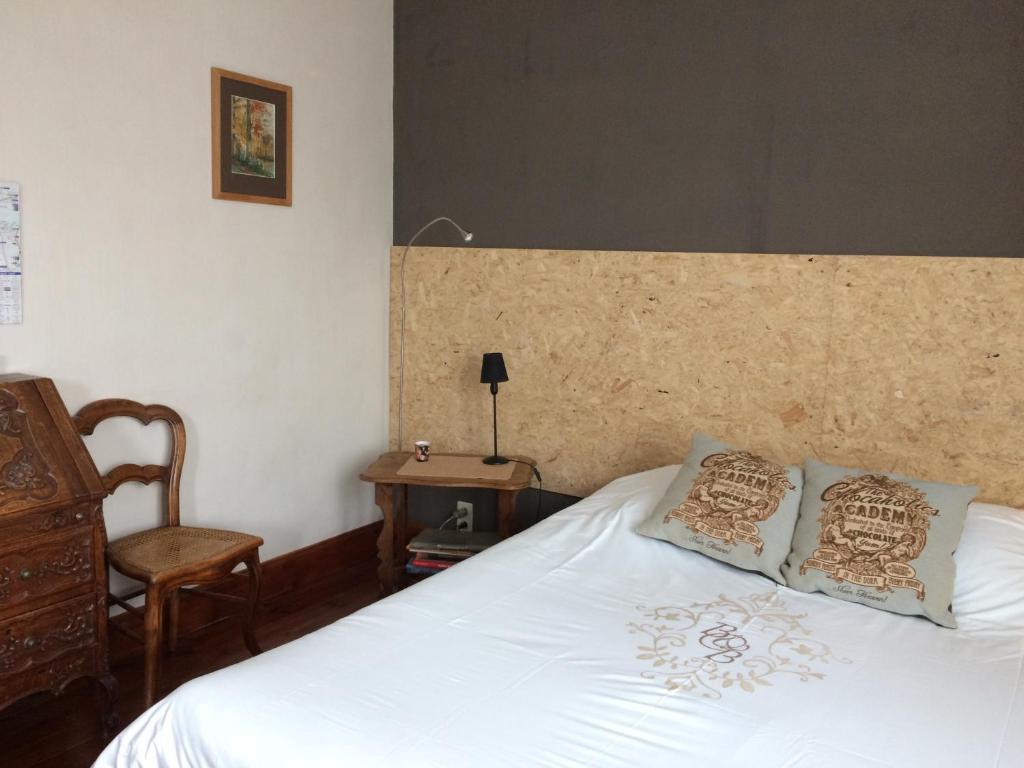 a bed with two pillows on it in a bedroom at B&B Chambre Chocolat in Brussels