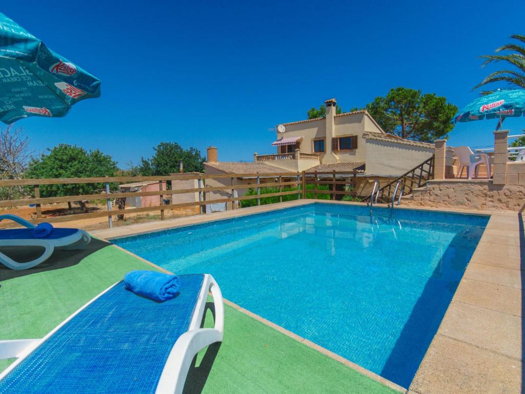 a swimming pool in front of a house at Holiday Home Clau de Sol - PIC160 by Interhome in Can Picafort