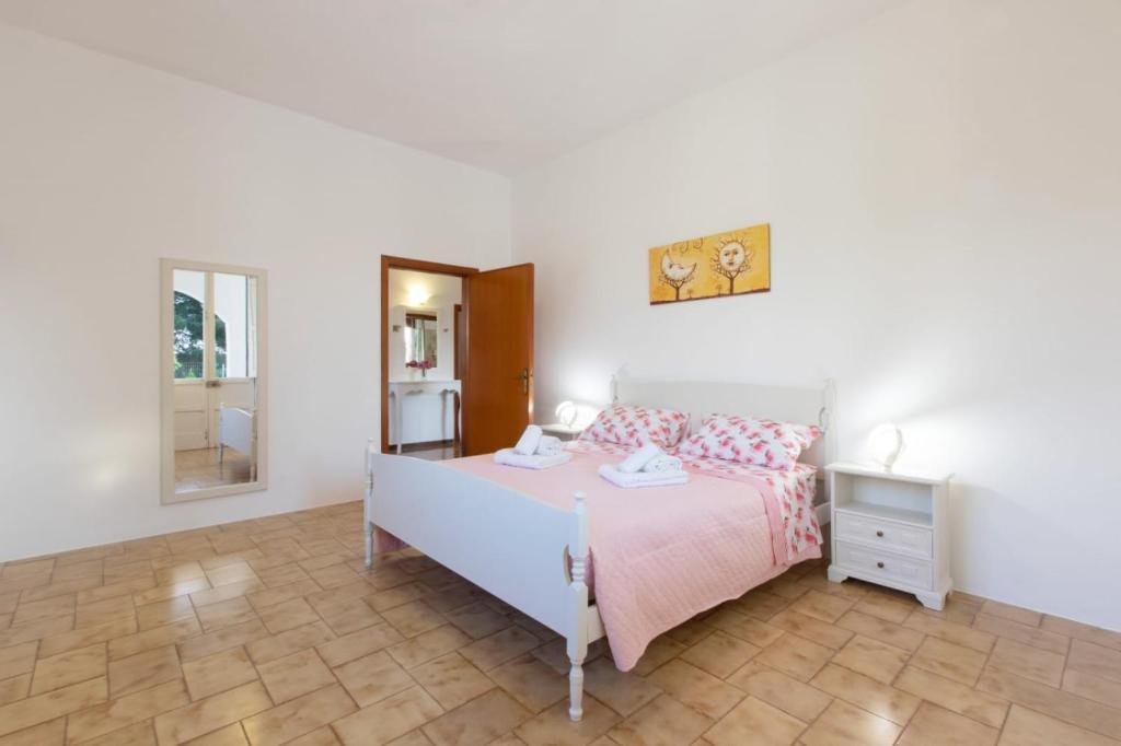 Postel nebo postele na pokoji v ubytování Villetta Goccia D'oro