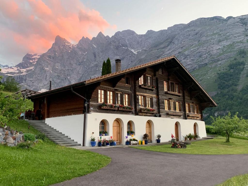 a large building with mountains in the background at Holiday Home Reindli by Interhome in Innertkirchen