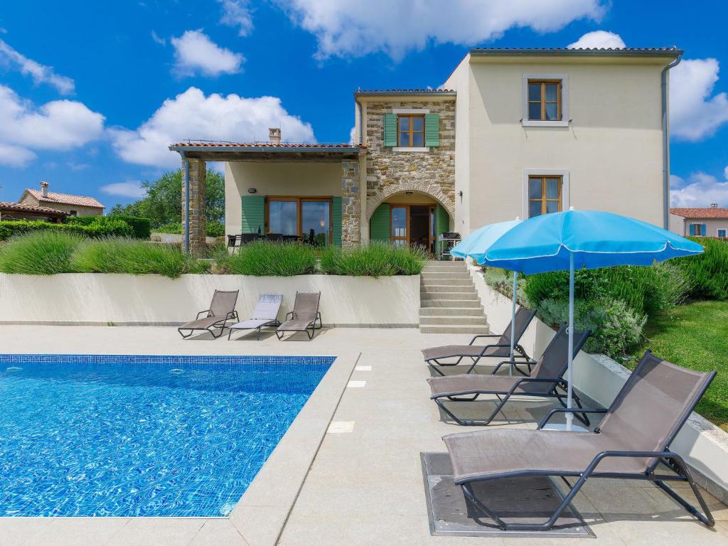a villa with a swimming pool and a house at Villa Stuartma by Interhome in Donje Baredine