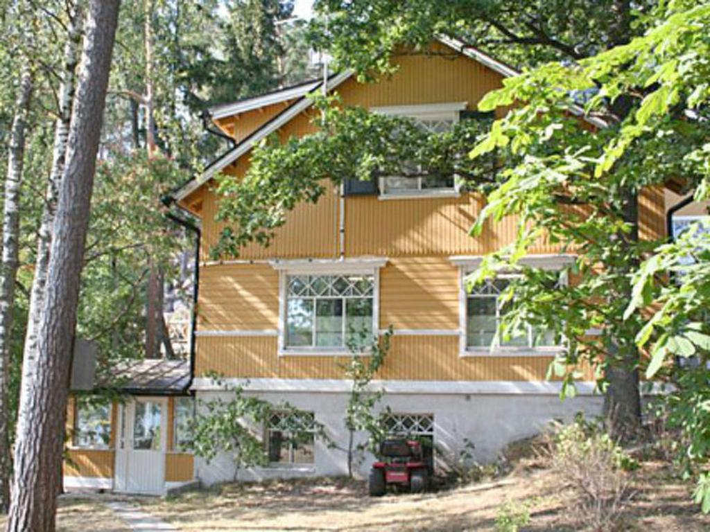 a house with a tree in front of it at Holiday Home Lövkulla by Interhome in Löparö