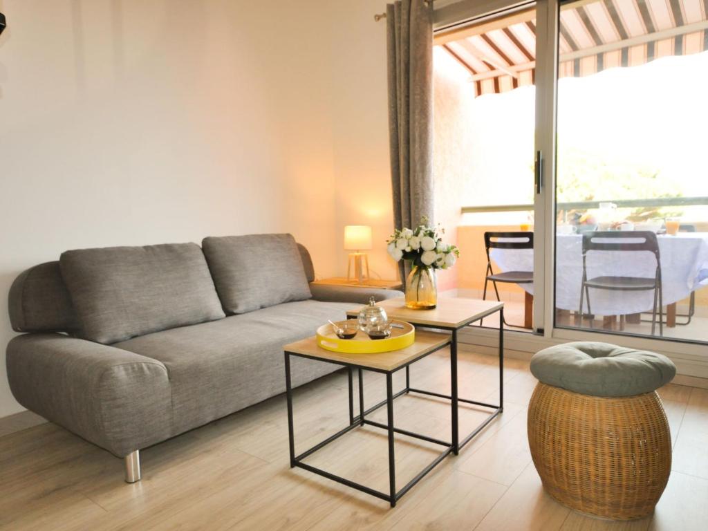 a living room with a couch and a table at Apartment Les Jardins d&#39;Amaryllis-8 in Cavalaire-sur-Mer