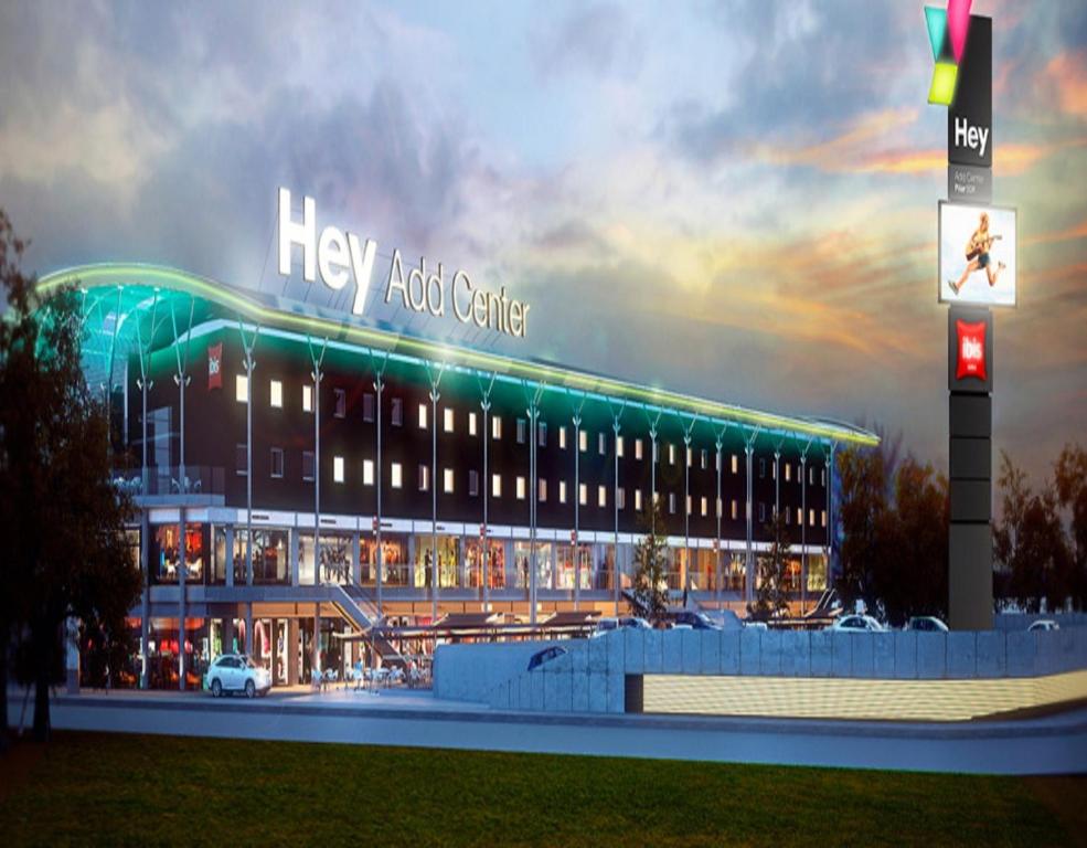 a large building with a lit up sign in front of it at ibis Pilar in Pilar