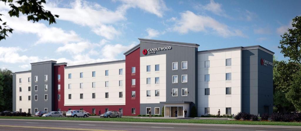 a large white and red building with cars parked outside at Candlewood Suites - Loma Linda - San Bernardino S, an IHG Hotel in Loma Linda