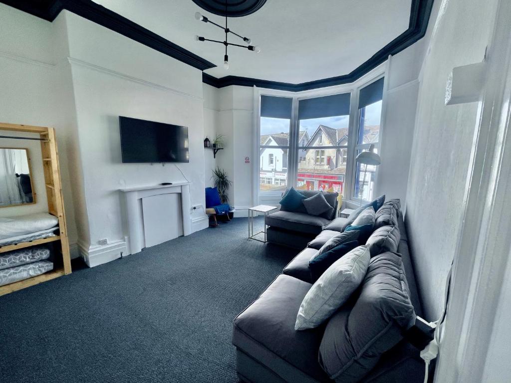 a living room with a couch and a fireplace at PolkaDot Winter Gardens - 2 x Large Modern Apartments, Central Blackpool in Blackpool