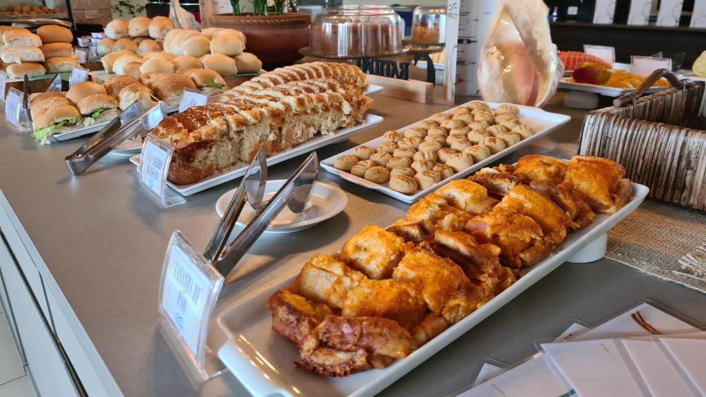 a buffet filled with different types of food on a table at Arena Carneiros Hotel by AFT in Tamandaré