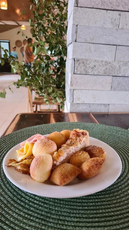 a white plate of food on a table at Arena Carneiros Hotel by AFT in Tamandaré