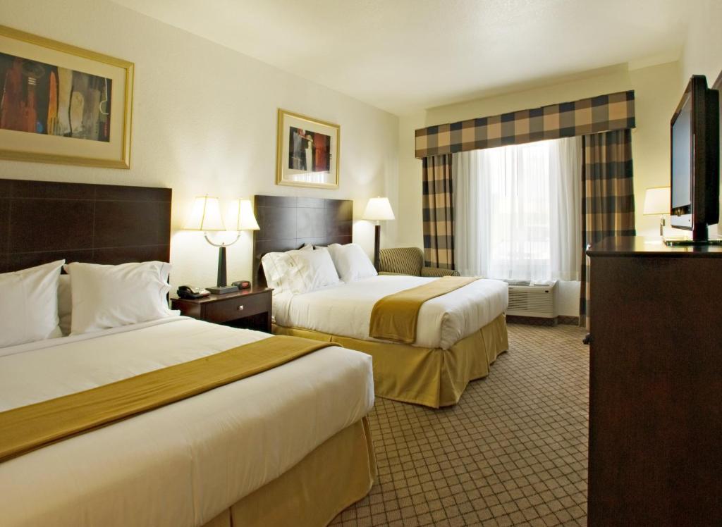 a hotel room with two beds and a flat screen tv at Holiday Inn Express & Suites Childress by IHG in Childress