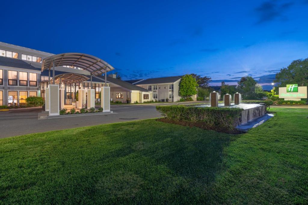 a rendering of a building with a grass yard at Holiday Inn Cape Cod - Hyannis by IHG in Hyannis