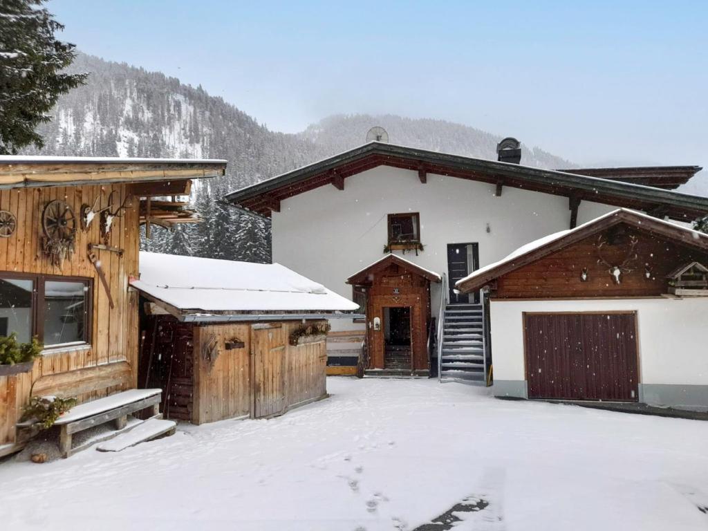 a house in the snow with a garage at Apartment Elisabeth by Interhome in Ochsengarten
