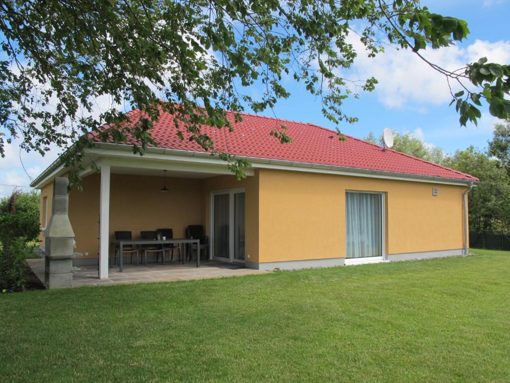 a yellow house with a red roof at Holiday Home Pusteblume by Interhome in Hessenburg