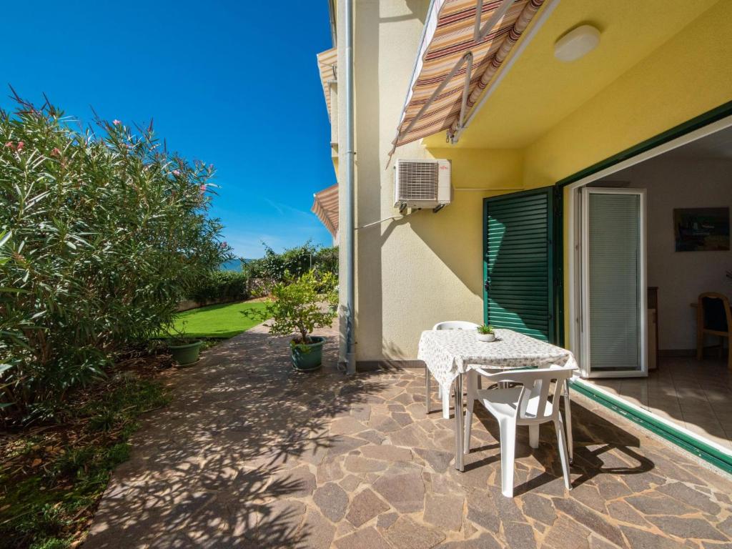 a patio with a table and chairs on a house at Studio Jasna-1 by Interhome in Pinezici