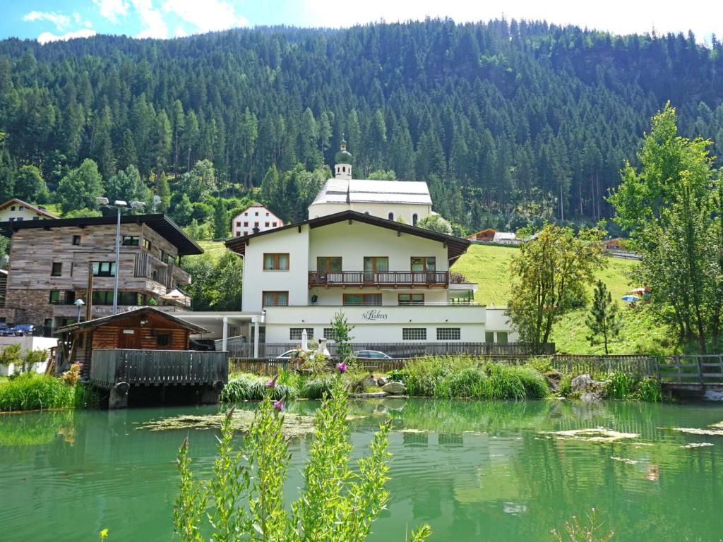 a building on the side of a river at Apartment Gams by Interhome in See