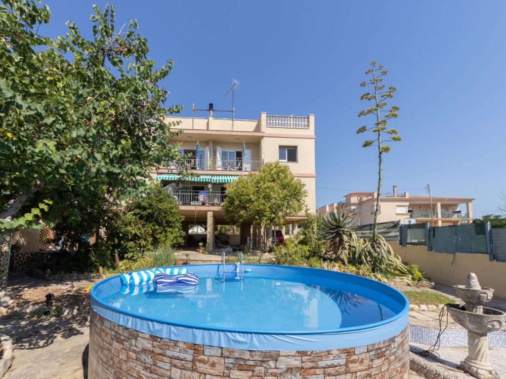 a large swimming pool in front of a building at Apartment Tabor-1 by Interhome in Torredembarra
