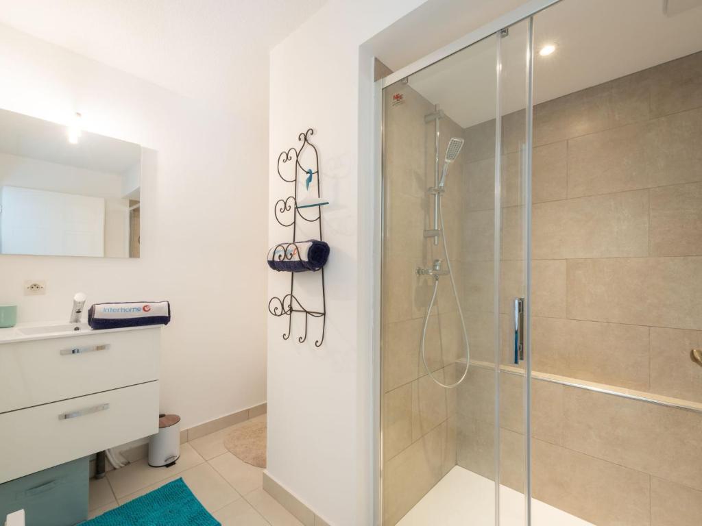 a bathroom with a shower with a glass door at Apartment Turquoise-10 by Interhome in Cavalaire-sur-Mer