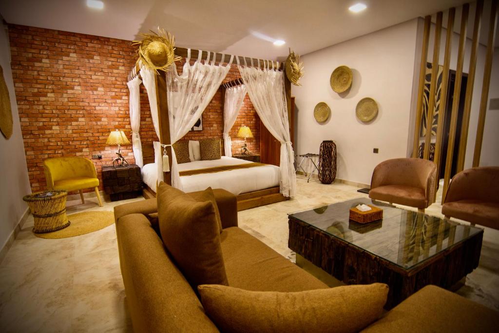 a living room with a bed and a couch and a table at Coastline Resort in Al-Musannah