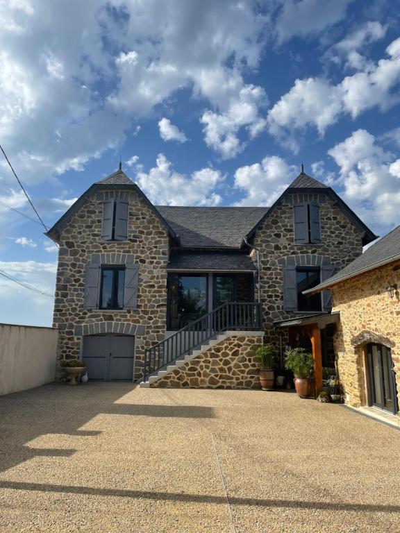 a stone house with a large driveway at Cottage Philmaries in Coudert
