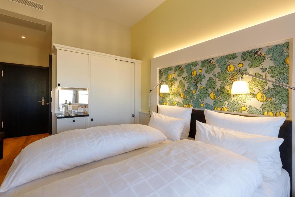 a bedroom with a white bed and a painting on the wall at Hotel Alte Post in Konstanz
