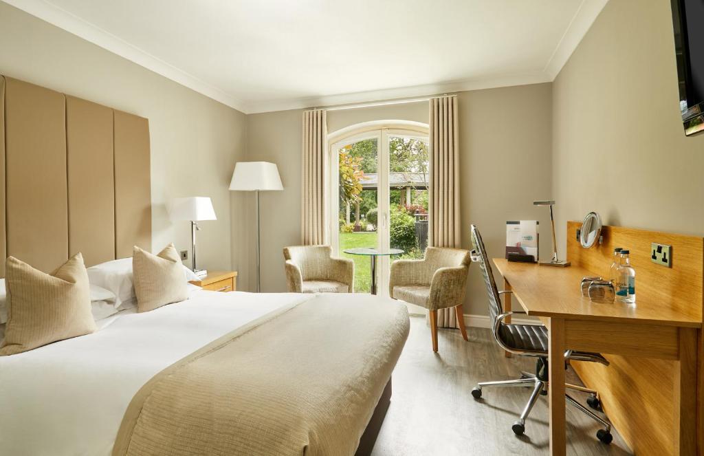 a hotel room with a bed and a desk at Lion Quays Resort in Chirk