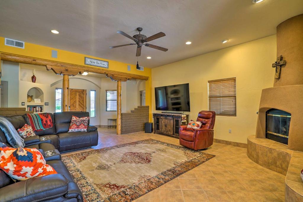 a living room with a couch and a fireplace at Rustic Las Cruces Escape - 2 Mi to NMSU! in Las Cruces