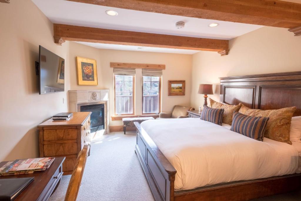 a bedroom with a large bed and a fireplace at Hotel King Hotel Room in Park City