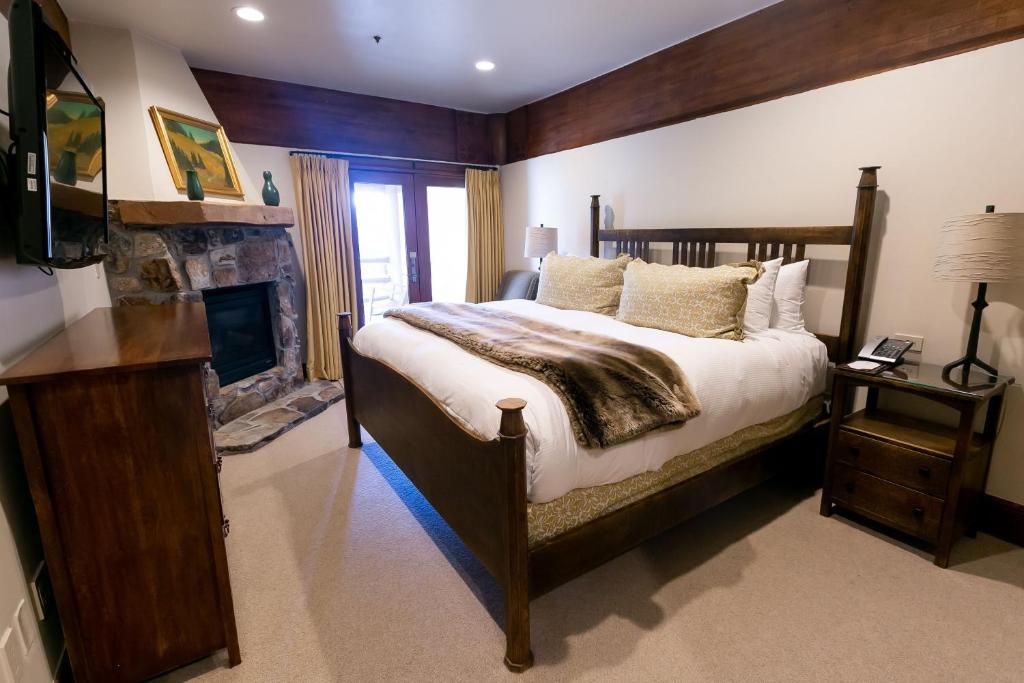 a bedroom with a large bed and a fireplace at Deluxe King Room with Fireplace Hotel Room in Park City