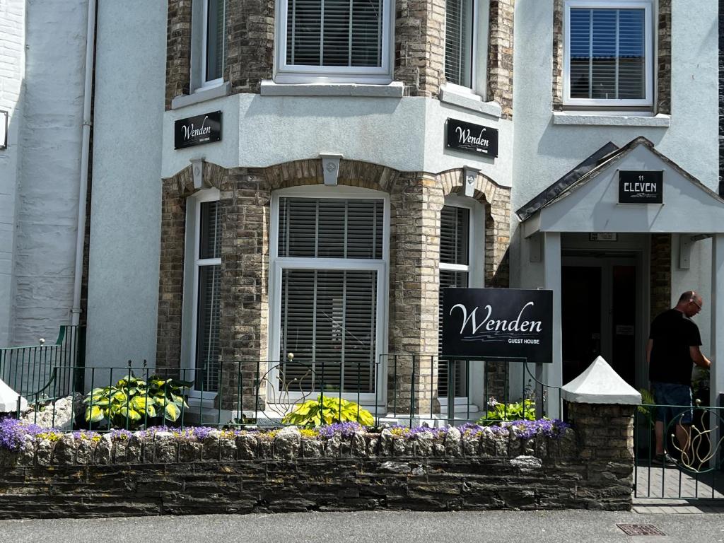 a man standing in front of a building at Wenden Guest House in Newquay