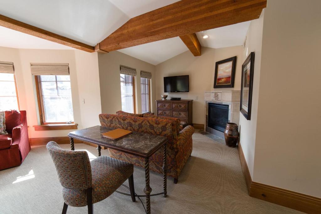 a living room with a couch and a table at Deluxe King Hotel Room in Park City