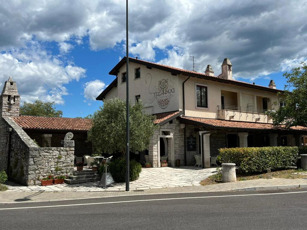 a building on the side of a street with a street pole at Gran Osteria Tre Noci in Sistiana