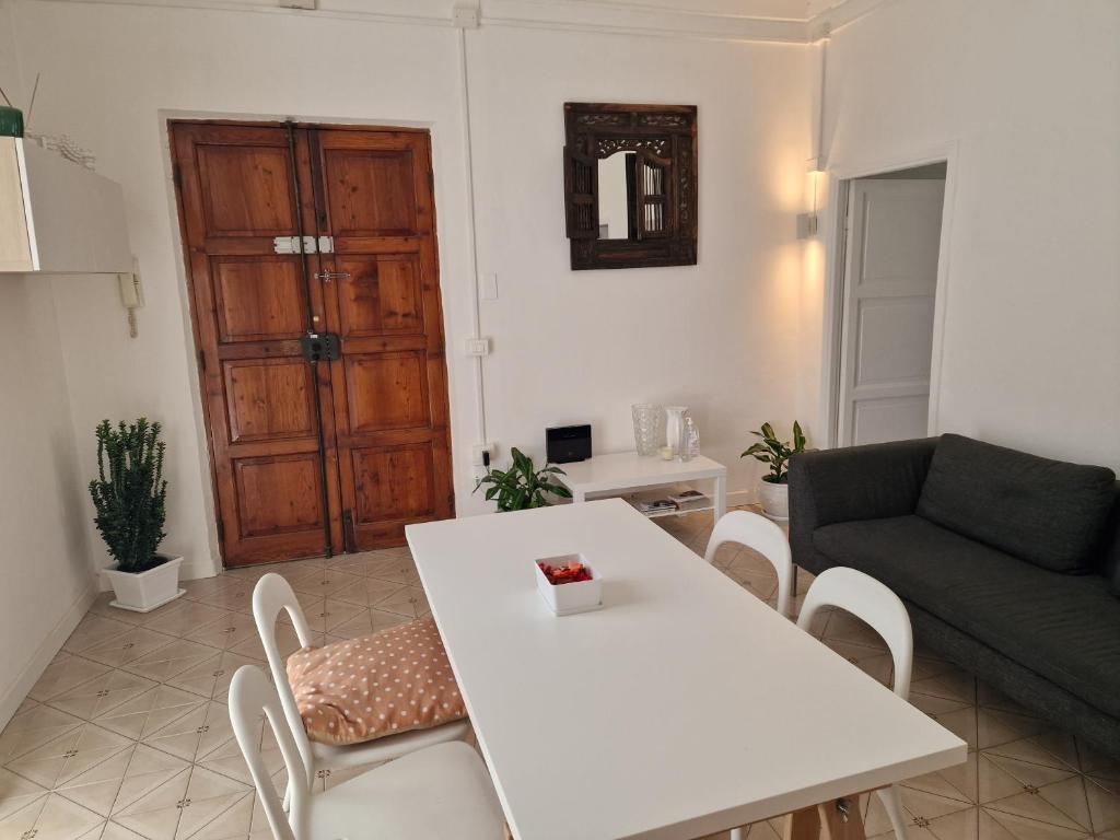 a living room with a white table and a couch at FRANGI HOUSE in Pescara