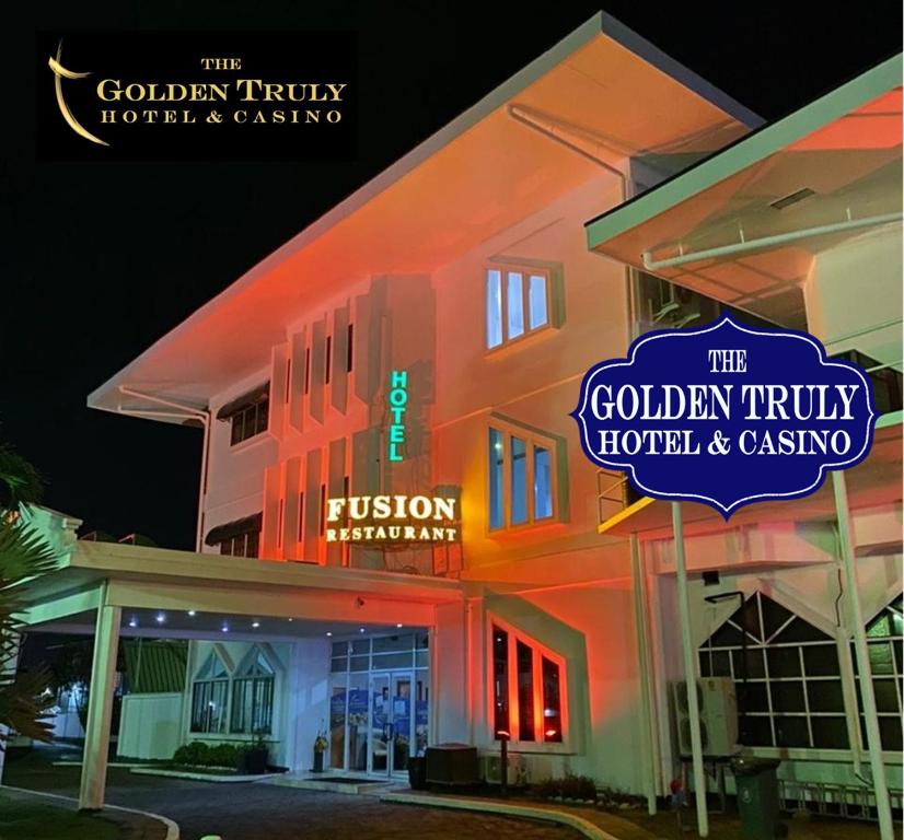 a hotel with neon signs on the side of it at The Golden Truly Hotel & Casino in Paramaribo