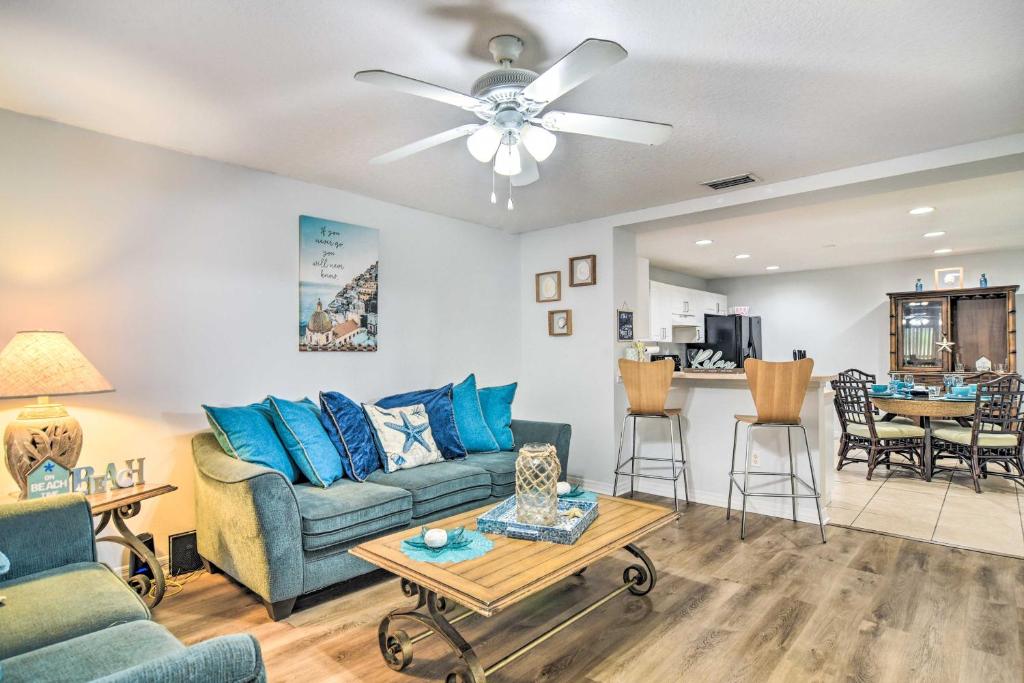 a living room with a couch and a table at St Pete Bungalow Less Than 2 Mi to Beach and Downtown! in St Petersburg