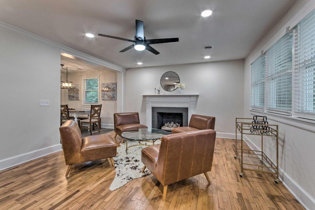 a living room with a table and chairs and a fireplace at Stylish Wilmington Home, 2 Mi to Riverwalk! in Wilmington
