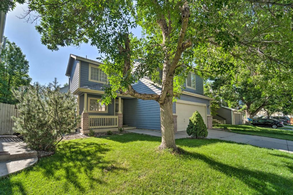 a house with a tree in the yard at Family Home with Fenced Yard 15 Mi to Denver! in Broomfield