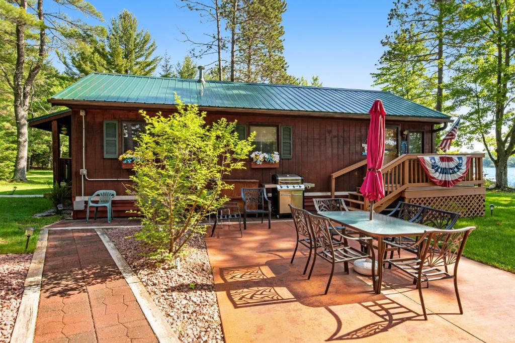 a cabin with a patio and a table and chairs at Catfish Cottage B in Eagle River