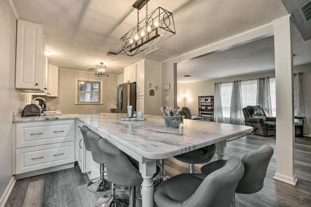 a kitchen with a large marble table and chairs at Updated High Point Retreat with Pool and Backyard in High Point