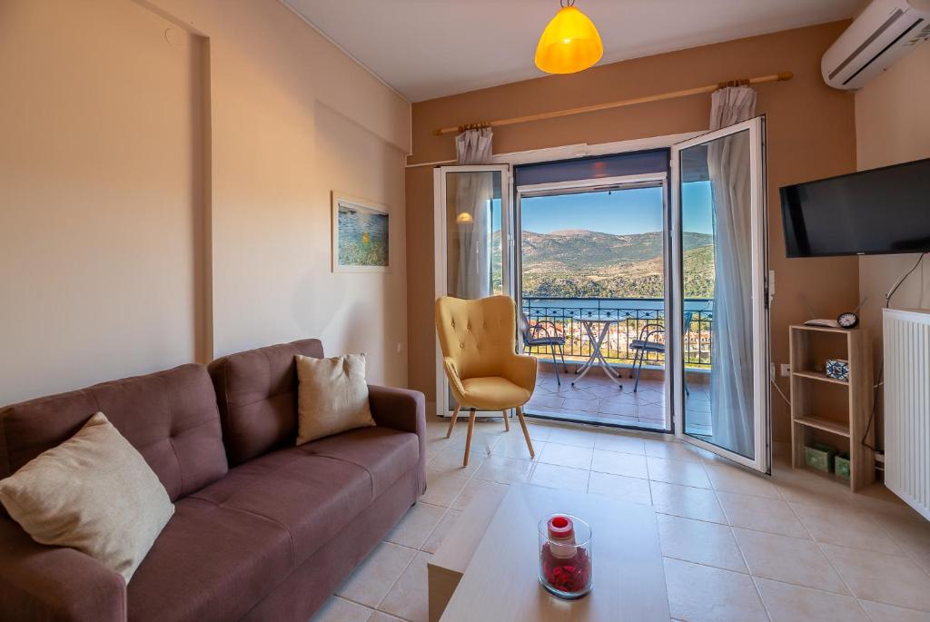 a living room with a couch and a balcony at Antigone Apartments Argostoli (Spilia) 2 in Argostoli