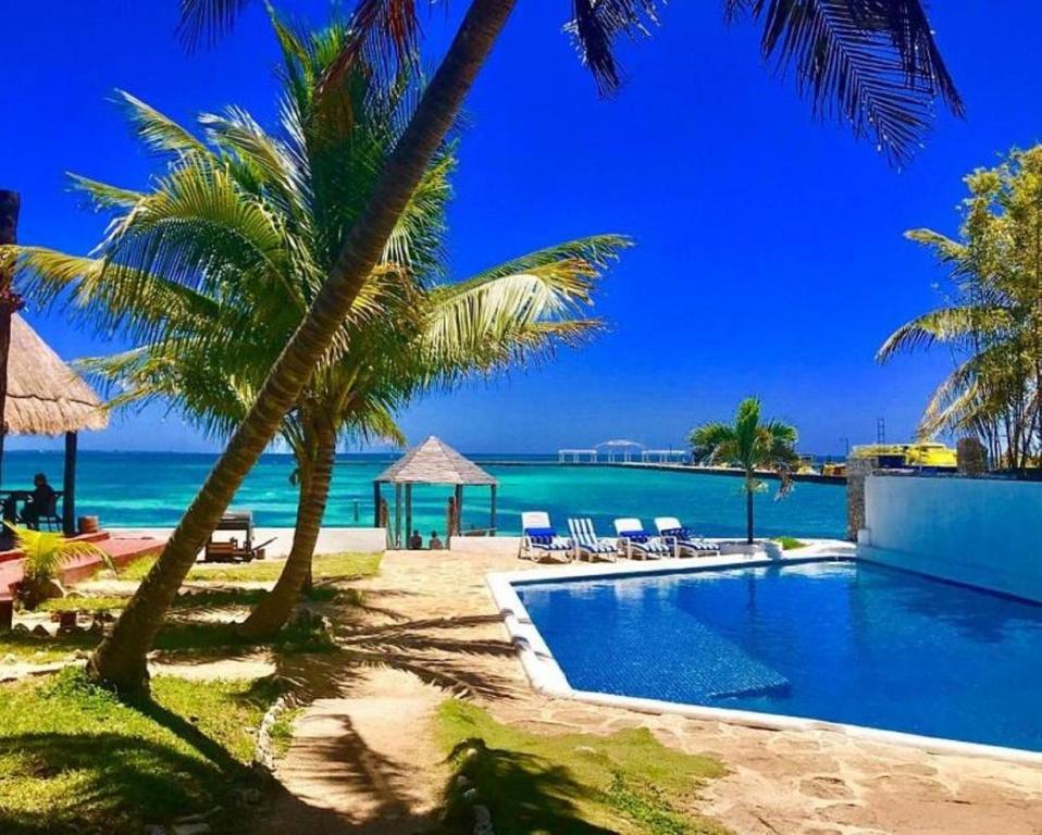 a swimming pool with a view of the ocean at Casa CARIBE Cancun in Cancún