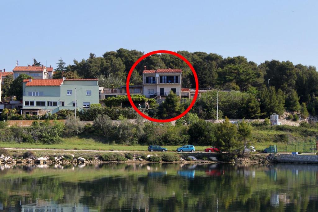 a house with a red circle around it next to the water at Apartments with a parking space Pula - 7681 in Pula