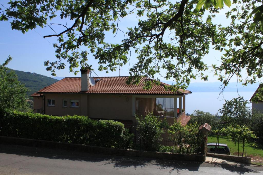 a house with a view of the ocean at Apartments with a parking space Opric, Opatija - 7726 in Opric