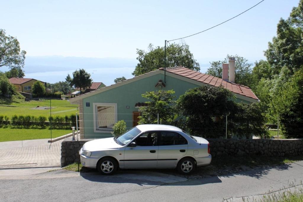 a white car parked in front of a house at Holiday house with a parking space Veprinac, Opatija - 7699 in Veprinac