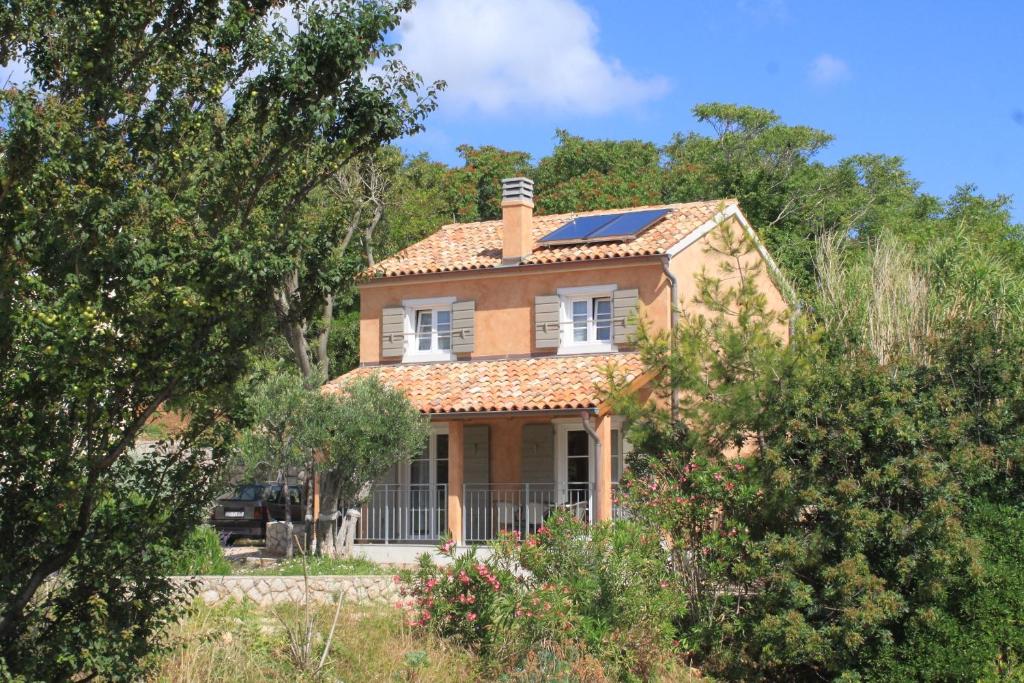 a house with solar panels on the roof at Holiday house with a parking space Nerezine, Losinj - 8016 in Nerezine