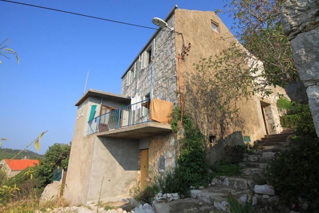 an old building on a hill with a balcony at Holiday apartments Lastovo - 7790 in Lastovo
