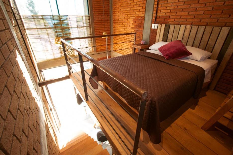 een bed in een kamer met een groot raam bij Rancho San Pablo in Oaxaca City