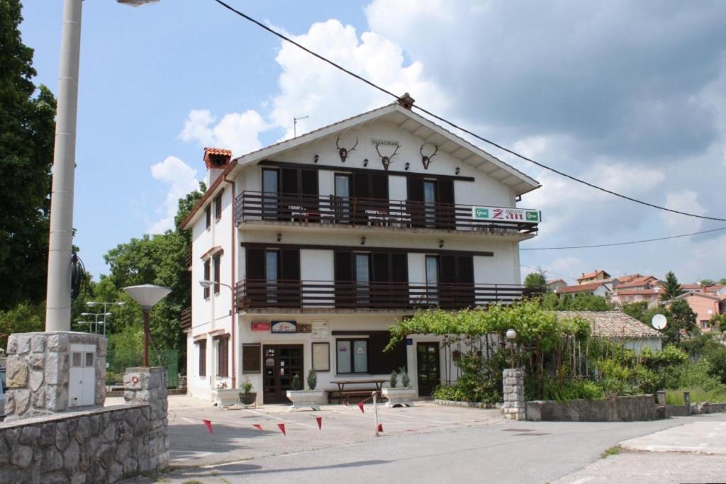 a white building with a balcony on top of it at Rooms with a parking space Veli Brgud, Opatija - 7840 in Jurdani