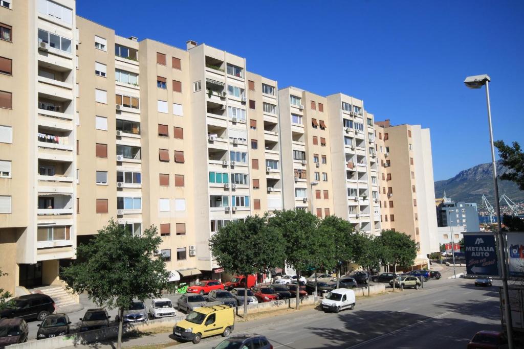 a parking lot with cars parked in front of tall buildings at Rooms with WiFi Split - 9240 in Split