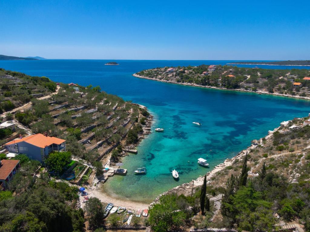 an aerial view of a beach with boats in the water at Seaside house for families with children Cove Stratincica, Korcula - 9265 in Vela Luka