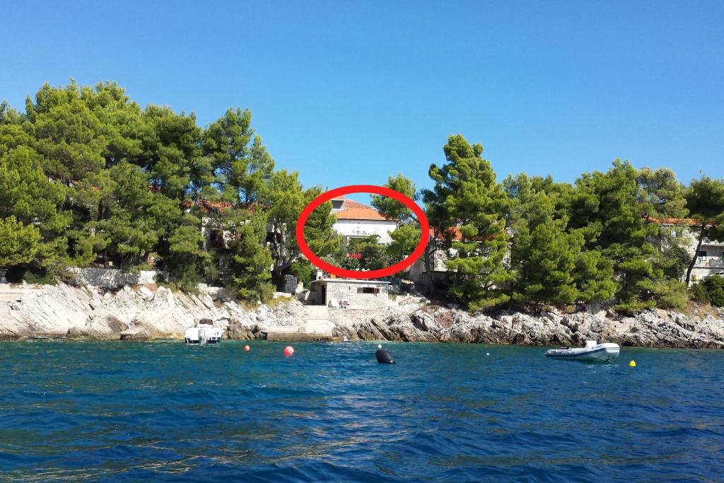 a house in the middle of a body of water at Apartments by the sea Brna, Korcula - 9296 in Smokvica